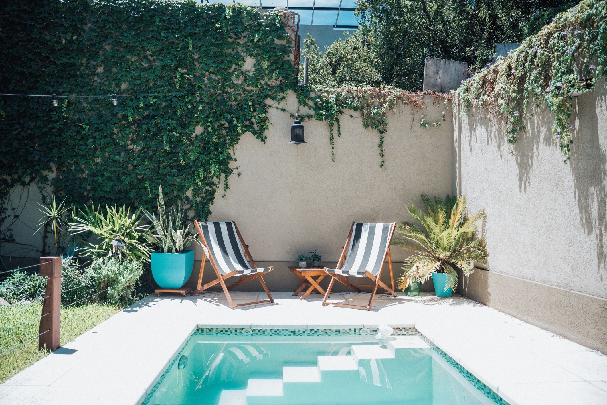 Poolside seating area representing a satisfied homeowner project
