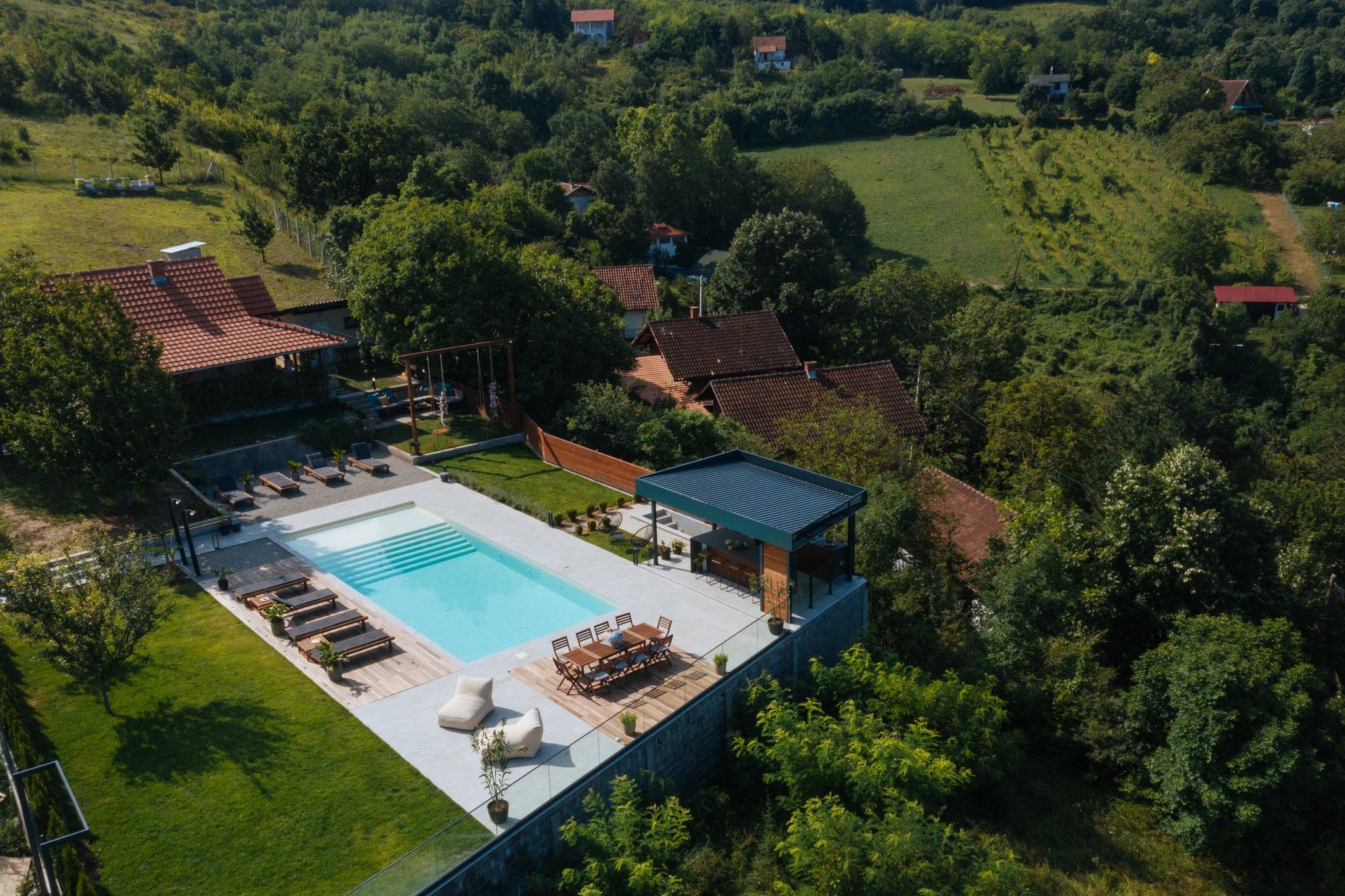Aerial view of a home with a custom pool